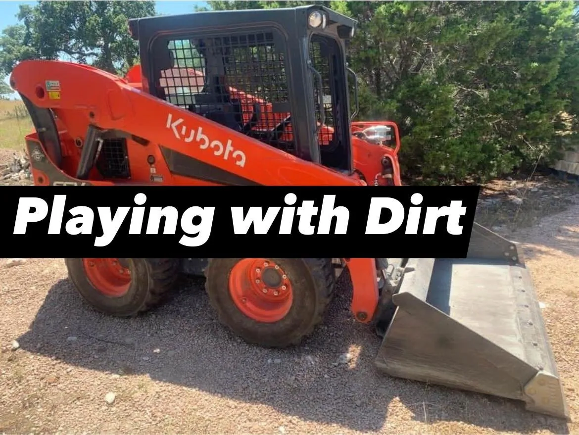 Skid steer clearing land on a Bertram-area property