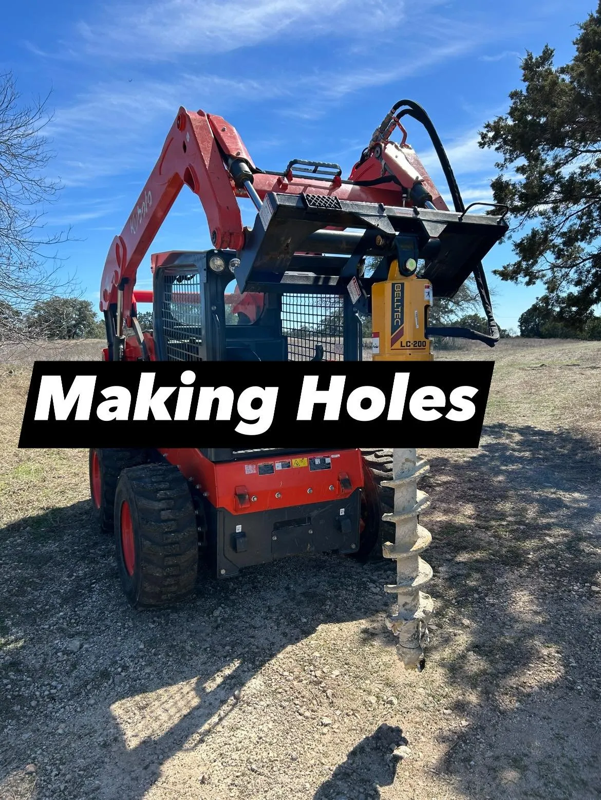 Skid steer mid-grade work on a driveway